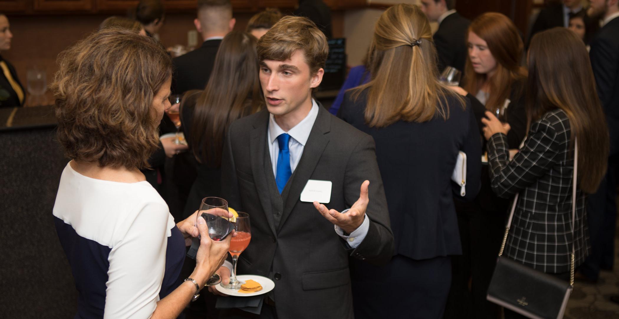 Patty Navin speaks with Graeson Michaud. Ohio Northern University Dicke College of Business Administration juniors participated in an etiquette dinner at The Inn at Ohio Northern University.